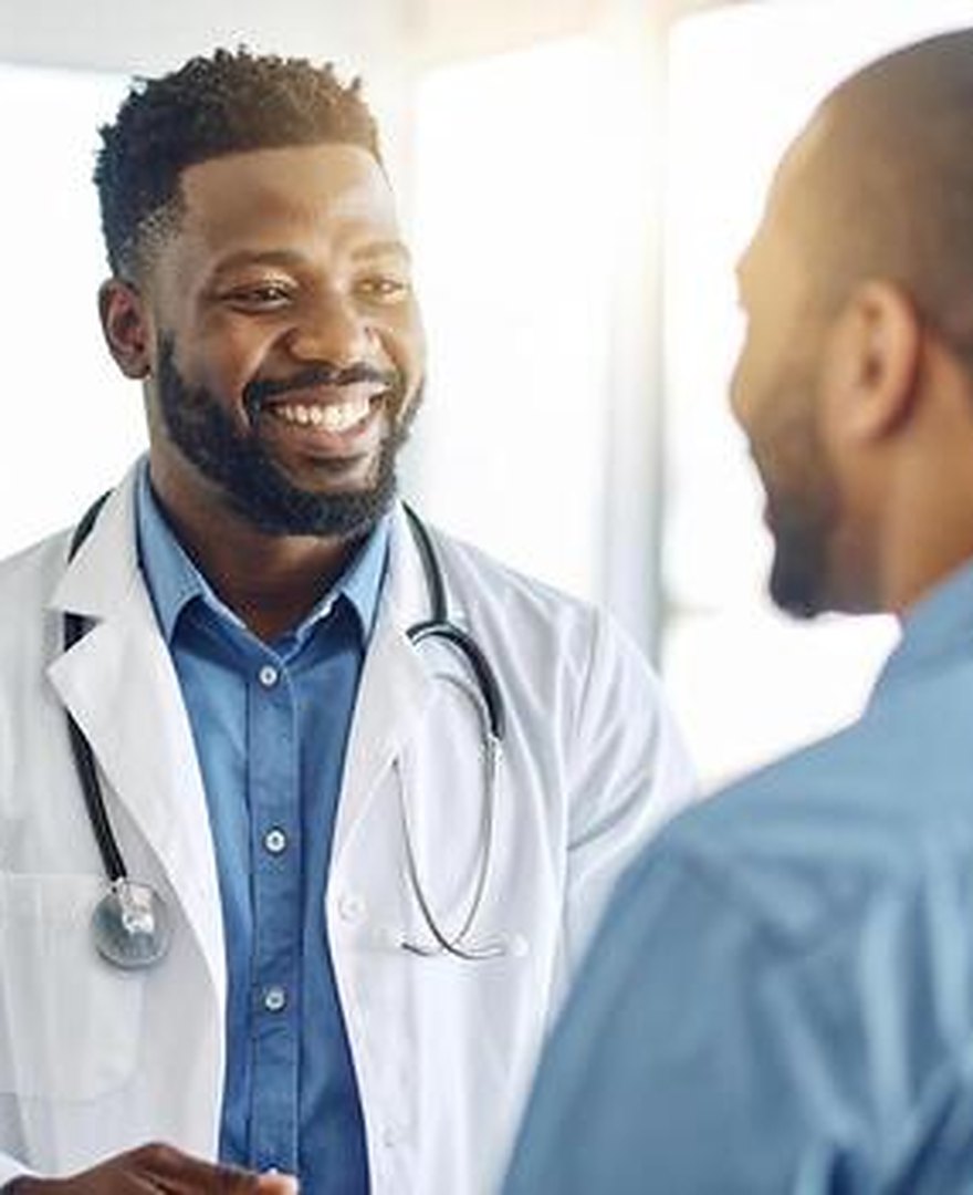 A doctor speaking warmly with a patient